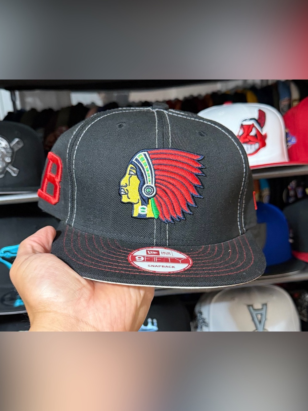 New Era Black Snapback Hat with Red Headdress Patch